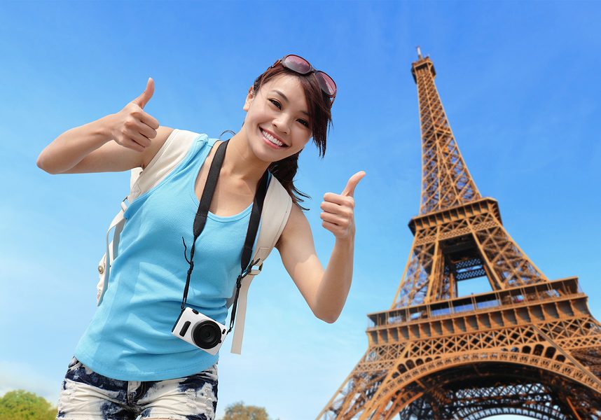 Happy travel woman in Paris with Eiffel Tower and she show thumb up asian beauty